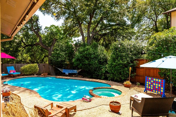 Escape to your personal backyard paradise, open 24/7 and boasts a heated swimming pool, bubbling hot tub, cozy sun loungers, a hammock, and an exciting array of games and pool toys for all year fun.