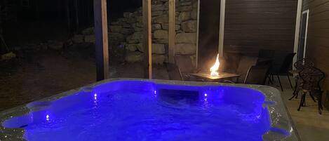Enjoy your private 7 person hot tub near the propane fire pit & outdoor seating!