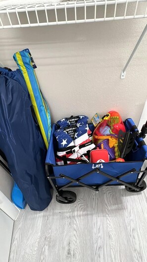 Beach essentials including beach chairs, umbrella, kids life jackets & sand toys