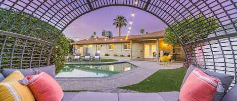 DREAM BACK YARD features large pool with Baja step; covered patio with dining table; putting green; gas fire pit;  sun loungers; Giant Jenga; and corn hole.
Pool can be heated for an add'l fee.