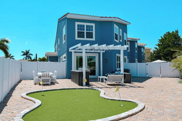 Practice your swing on the backyard putting green, a perfect spot for fun and relaxation