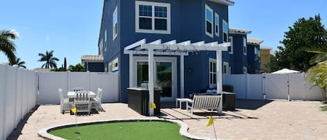 Patio entertaining area with brand new outdoor kitchen, dining area & putting green!