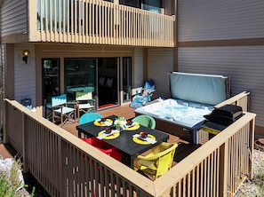 Spacious deck with patio seating, outdoor dining and soothing hot tub