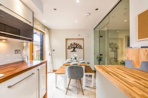 The open plan kitchen diner is stylish and spacious, with bi-fold doors to let the breeze in on warmer days.