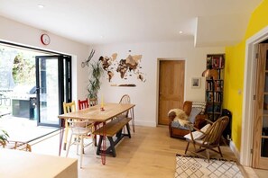 The open plan kitchen diner is stylish and spacious, with bi-fold doors to let the breeze in on warmer days.