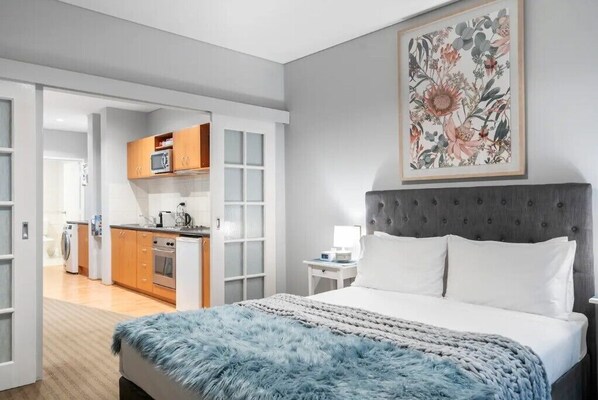 Bedroom with French doors to kitchen, living and bathroom