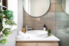 The bathroom is immaculately presented with a shower, toilet and mirrored basin.