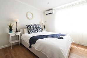 Sleep easy in a premium bed topped with luxury linens. Sheer and blackout curtains ensure a sleep in while air conditioning keeps you cool in the warmer months.