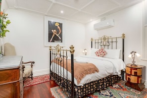 The second bedroom features a queen-size bed and charming, vintage-inspired accents. 