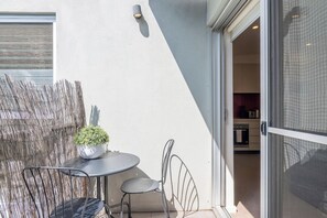 The sunlit private patio allows for natural ventilation and a seamless connection with the outdoors.