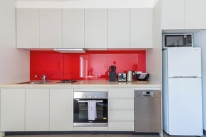 The kitchen is fully-equipped for a meal at home with a fridge/freezer, dishwasher, oven, stove, kettle and toaster.