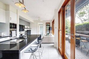 Cook all your meals in a stunning kitchen with black marble benchtops that features high-end appliances