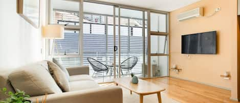 Clean simple lines through the living room lead out to the private balcony.