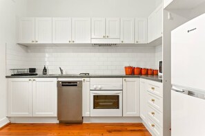 The kitchen hosts all the basics needed for cooking up a meal and has a dishwasher to make that easier.
