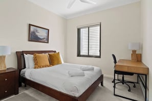 The second bedroom is set with a queen and comes with a dedicated workspace for those on business.
