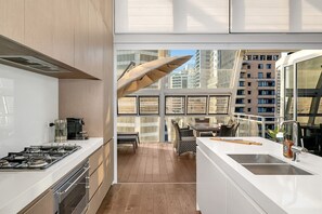 Sliding doors in the kitchen open up to allow for a seamless indoor-outdoor flow.