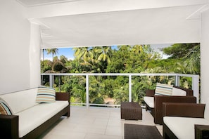 Relax after a big day out on the private balcony. It frames lush tropical views and has comfortable outdoor seating.