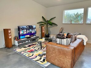 Living Room: TV, Speakers, and Sofa Bed