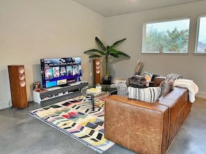 Living Room: TV, Speakers, and Sofa Bed