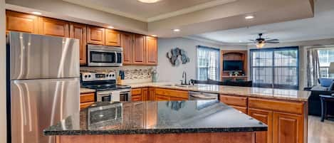 Large fully stocked kitchen with pots, pans, crock pot, coffee pot, and keurig.