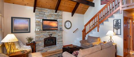 Comfortable living room space with plenty seating, television and gas fireplace.