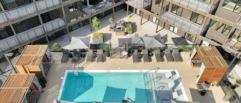 Communal Area: Pool Season Grand Opening - May 1st, 2024! Sparkling Blue Pool with covered cabanas, sun loungers, and a wheelchair lift.