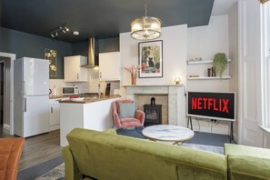 Stylish Living Room: Chic decor, vibrant colors, and streaming-ready vibes await your adventure!