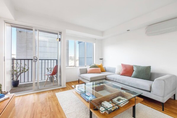 The bright and airy living room is the perfect place to unwind. Please note that the air-conditioning is currently under repair but portable fans are provided. 