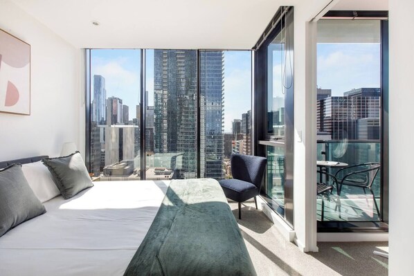 The light-filled first bedroom features stunning views overlooking the city from the comfort of a queen-size bed. 
