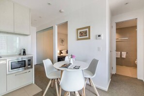 The open-plan kitchen and dining area offers a four-seater table where guests can share meals.