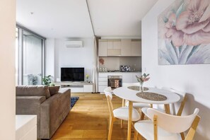 The living room/dining area offers easy access out to the balcony.
