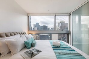The bedroom boasts wall to wall windows to look out at stunning city views.