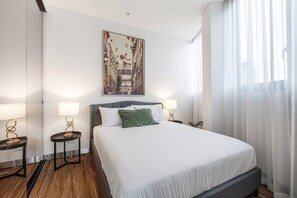 The second bedroom is elegantly styled with a comfortable queen-sized bed.
