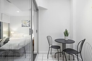 The bedroom area flows out to the enclosed patio with alfresco dining.