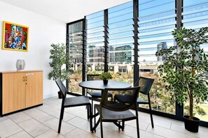 The enclosed balcony features picturesque views for your to enjoy while dining alfresco.