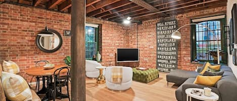 Defined by ornate brickwork, exposed ceilings and rustic timber, the open plan living area oozes industrial style with retro touches.