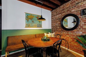 Dine together at the round table with bench seating and three bistro chairs.