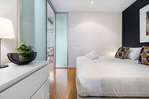 Spread out in the king-size bed after a long day of exploring Melbourne. The bedroom also includes a drawer chest for your belongings.