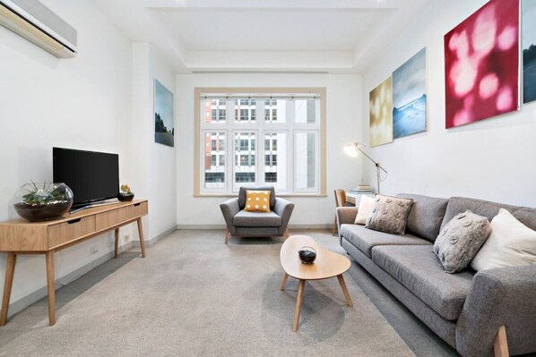 The living area offers comfortable seating in from of the flat-screen TV