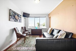 Kick back on the leather L-shaped lounge in front of the wall-hung TV.