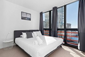 The main bedroom features a plush queen bed, plenty of storage and views out onto the river.