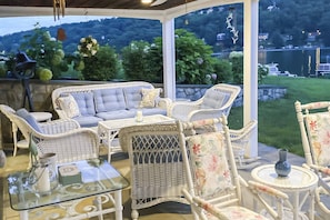 Covered bluestone patio cozy seating, overlooking lake