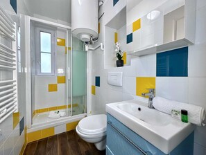A full equipped bathroom with shower