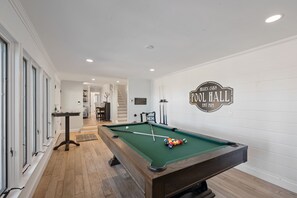 Pool room features a billiards table and TV.