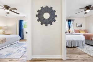 A peek down the hall reveals two cozy bedrooms, each thoughtfully designed for a restful stay