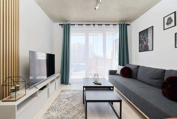 Living room with a comfortable sofa and TV. 