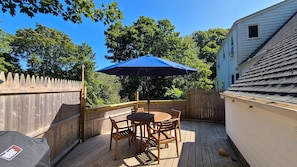 Private back deck with teak furniture and gas grill