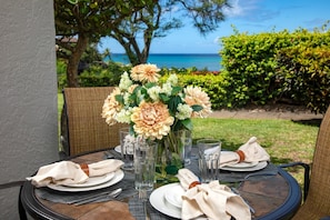 Dine steps from the sea where garden blooms and ocean views meet?your alfresco table is set for paradise NAP-A25
