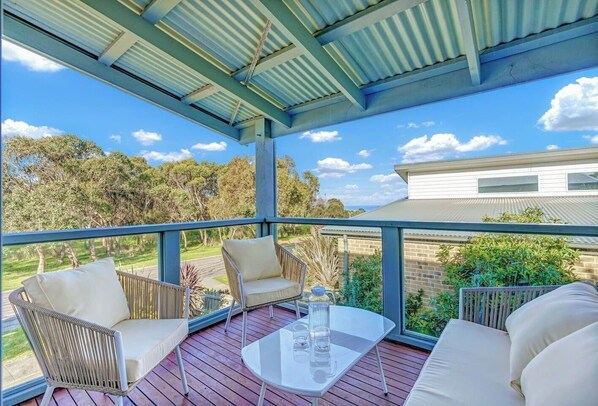 A covered balcony has al fresco lounges and ocean views and is the ultimate place to enjoy an afternoon drink.
