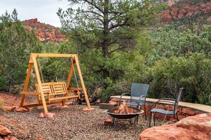 Cozy up to a warm fire around the firepit and relax on the swing. 